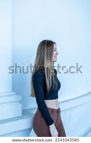 Similar – Happy young woman with moving hair in urban background