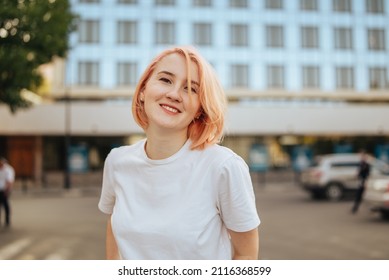 Young blonde woman smiling happy outdoors city street portrait