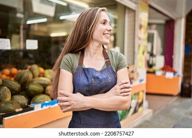 Young Blonde Woman Smiling Happy Wearing Apron At Fruit Store