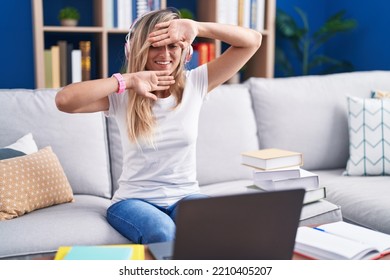 Young Blonde Woman Studying Using Computer Laptop At Home Smiling Cheerful Playing Peek A Boo With Hands Showing Face. Surprised And Exited 