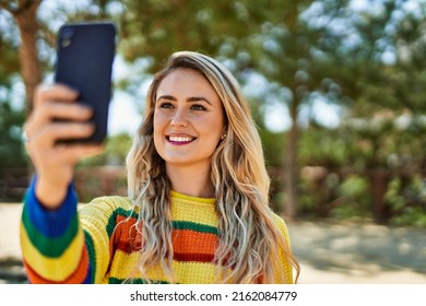 Young Blonde Woman Taking Selfie Picture At The Park