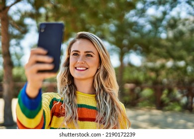 Young Blonde Woman Taking Selfie Picture At The Park