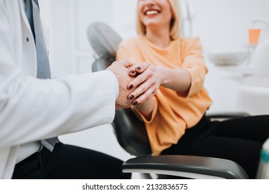 A Young Blonde Woman Talks With Her Dentist About Dental Treatment.