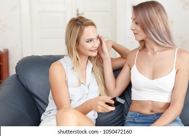 Young Blonde Woman Touching Girlfriends Face Stock Photo (E pic