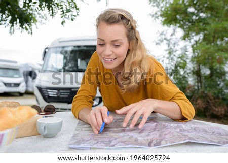 Similar – Image, Stock Photo Young women looking road map with 4×4 on background