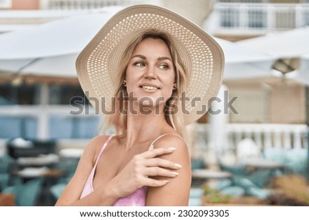 Young blonde woman tourist smiling confident standing at coffee shop terrace