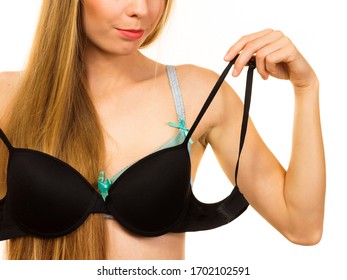 Young Blonde Woman Trying On Black Push Up Bra. Bosom Concept.