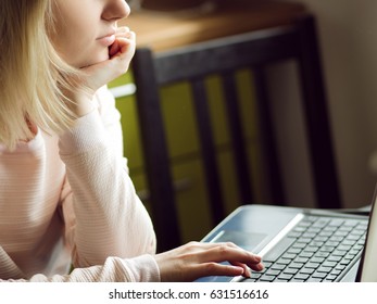 Young blonde woman uses a laptop, sitting at home. Concept of work in Internet - Shutterstock ID 631516616