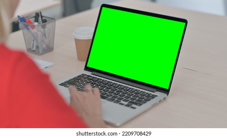 Young Blonde Woman Using Laptop With Green Chroma Key Screen