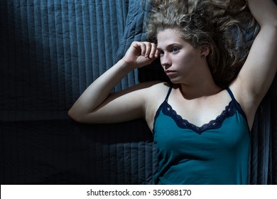 Young Blonde Woman Waking Up At Night