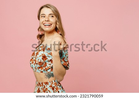 Young blonde woman wear summer casual clothes point thumb finger aside indicate on workspace area copy space mock up isolated on plain pastel light pink background studio portrait. Lifestyle concept