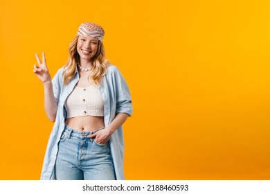 Young Blonde Woman Wearing Bandanna Smiling And Showing Peace Sign Isolated Over Yellow Background