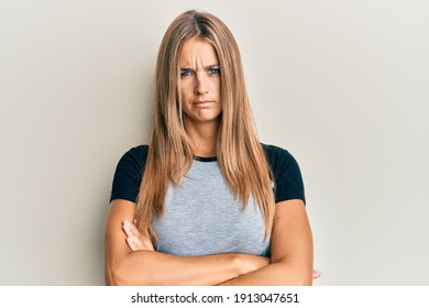 Young Blonde Woman Wearing Casual Clothes Skeptic And Nervous, Disapproving Expression On Face With Crossed Arms. Negative Person. 