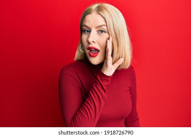 Young Blonde Woman Wearing Casual Clothes Hand On Mouth Telling Secret Rumor, Whispering Malicious Talk Conversation 