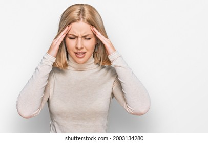 Young Blonde Woman Wearing Casual Clothes With Hand On Head For Pain In Head Because Stress. Suffering Migraine. 