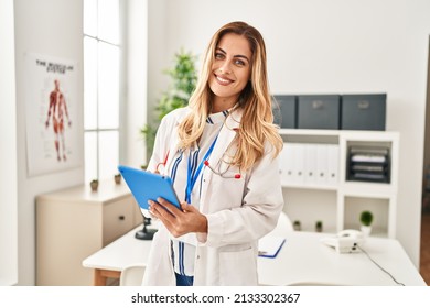 Young blonde woman wearing doctor uniform using touchpad at clinic - Powered by Shutterstock