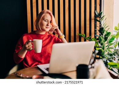 Young Blonde Woman Wearing Red Casual Sweater In Cafe Working On The Laptop Computer And Drinking Coffe Lifestyle