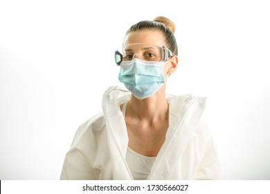 young blonde woman in white protective suit with goggles and medical mask on grey background