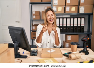 Young Blonde Woman Working At Small Business Ecommerce Pointing Fingers To Camera With Happy And Funny Face. Good Energy And Vibes. 