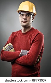 Young Blue Collar Worker With Yellow Protective Helmet And Gloves