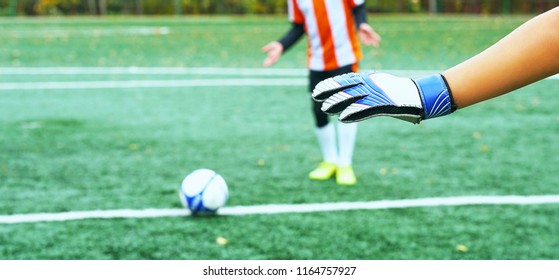 Young blurred soccer player taking a penalty kick against goal net. - Powered by Shutterstock