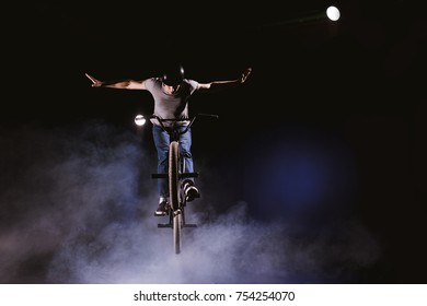 young bmx cyclist in helmet jumping with bicycle in smoke - Powered by Shutterstock