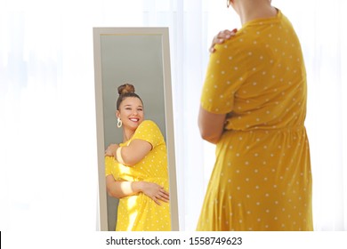 Young Body Positive Woman Looking In Mirror At Home