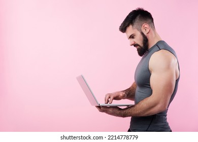 Young Bodybuilder, Online Fitness Coach, Using A Laptop And A Headset To Talk To An Online Client, Studio Image