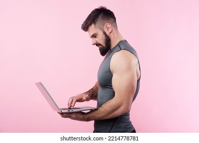 Young Bodybuilder, Online Fitness Coach, Using A Laptop And A Headset To Talk To An Online Client, Studio Image