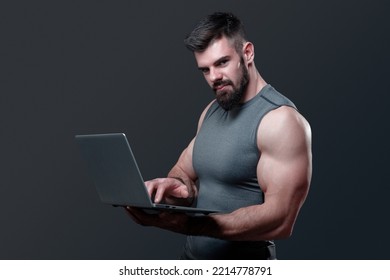 Young Bodybuilder, Online Fitness Coach, Using A Laptop And A Headset To Talk To An Online Client, Studio Image