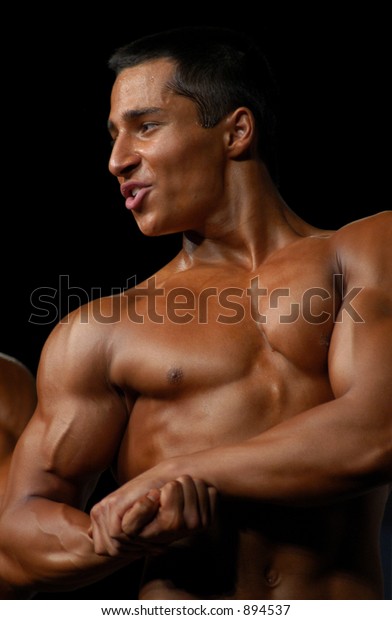 Young Bodybuilder Posing During Junior Bodybuilding Stock Photo (Edit