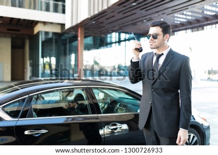Young bodyguard preparing security measures and contingency plans for high-ranking government official