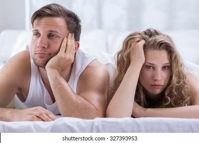 Young Bored Couple Having Problems In Bedroom