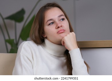 Young bored woman teenager sitting in armchair at home, sad depressed upset frustrated girl - Shutterstock ID 2241799351