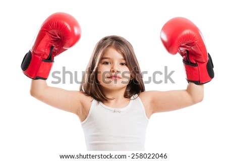 Young boxer girl raising arms up and wearing red gloves
