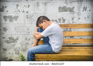 Young Boy Alone On Bench