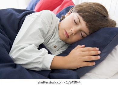 Young Boy Asleep In His Bed