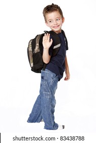 Young Boy With Backpack Waving Goodbye