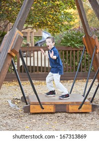 Young Boy Being Silly At The Park In Autumn