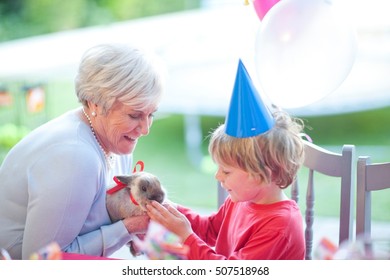 Young boy at birthday party with present from gran - Powered by Shutterstock