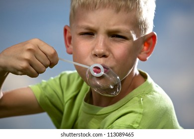 Young boy blowing bubbles