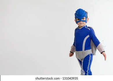 A Young Boy In A Blue Superhero Suit With Copy Space