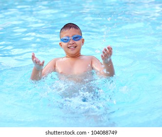 young boy in blue water of the swimming pool