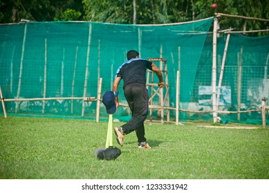 Young boy bowling around a cricket ground unique photo - Powered by Shutterstock