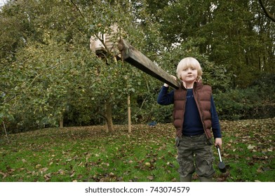 Young Boy Building Treehouse