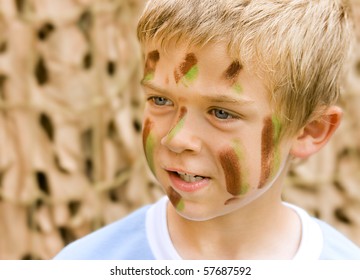 A Young Boy With Camouflage Paint On His Face