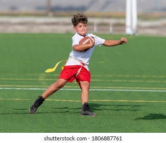 Young Boy Catching, Running And Throwing The Ball In A Football Game