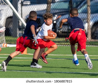 Young Boy Catching, Running And Throwing The Ball In A Football Game