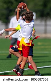 Young Boy Catching, Running And Throwing The Ball In A Football Game