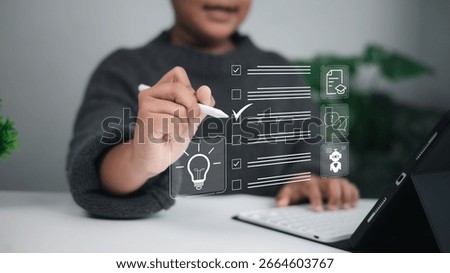 Young boy checking off a task on a digital checklist using a stylus pen on tablet, with icons like lightbulb, document, and chatbot, symbolizing task management, creativity, and education.